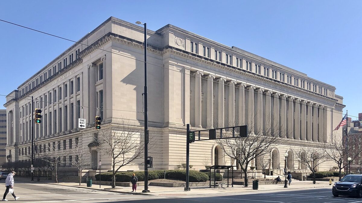 The columned stone facade of the Hamilton County Courthouse, with an inscription about the administration of the law carved across the frieze.