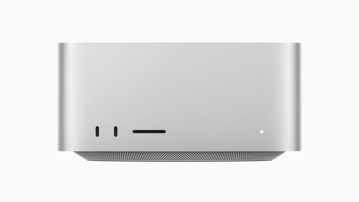 Apple's press photo of the Mac Studio shot head on, a squat silver aluminum block with two USB-C ports and an SD card slot across the front, on a plain white background