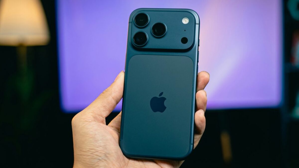 A person holding a blue iPhone, showing the rear camera module