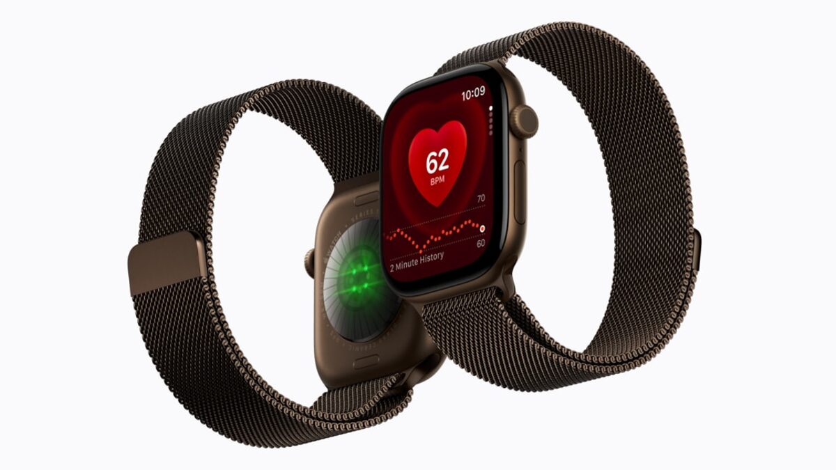 Two gold Apple Watch Series 12 models with Milanese loop bands, one showing a 62 BPM heart rate screen and one turned to show the green sensor lights on its back