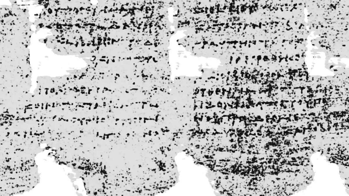 A carbonized, charred ancient papyrus scroll from Herculaneum, blackened and sealed by volcanic heat.