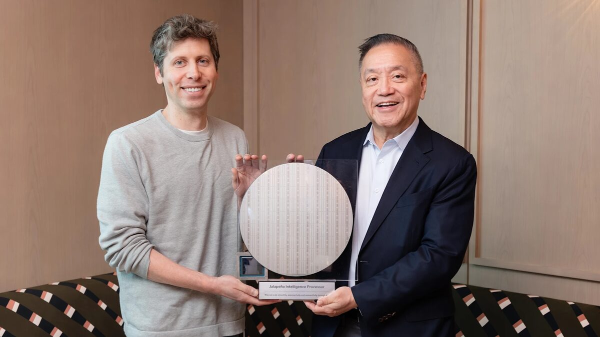 Sam Altman and Broadcom CEO Hock Tan holding a Jalapeño Intelligence Processor wafer mounted in an acrylic display