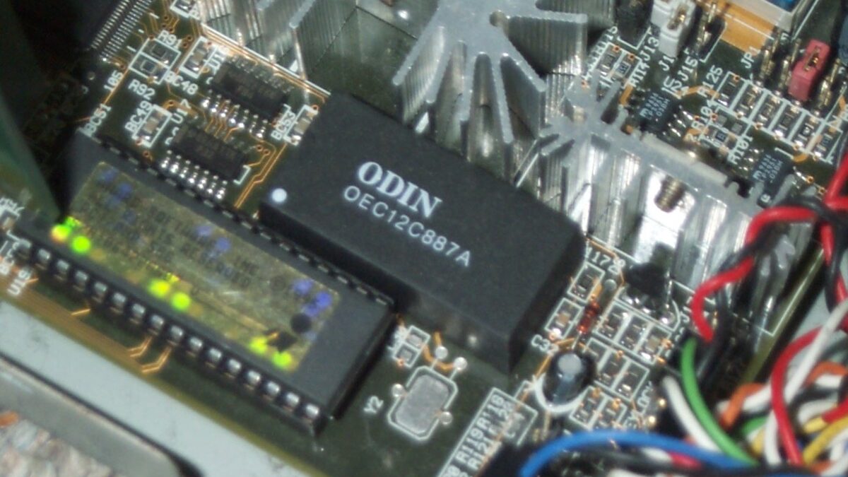 Close-up of an AT motherboard showing the socketed BIOS chip and real-time clock, the low-level firmware where Secure Boot certificates live.