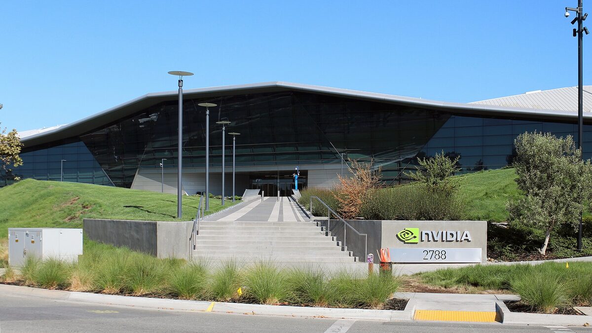 The low glass-and-steel Nvidia headquarters building in Santa Clara, with the green Nvidia eye logo and the street number 2788 on a concrete monument sign beside the entrance steps