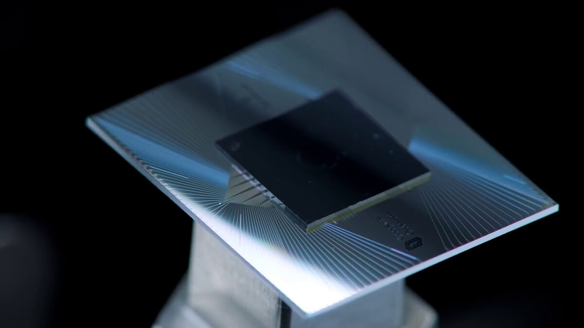 Close-up of Google's Sycamore quantum processor chip mounted on its gold-plated wiring harness.