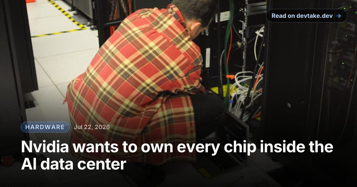A technician crouches with a laptop to service a black server rack in a data center, colored network cables running down the side