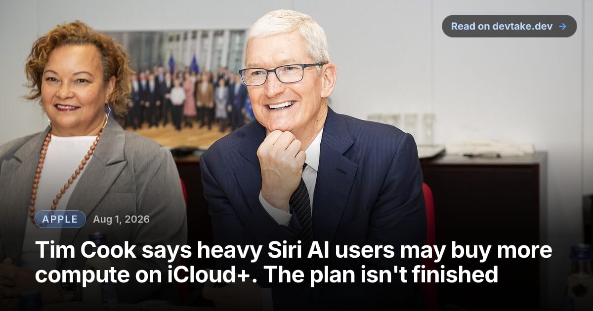 Tim Cook seated at a meeting table, smiling, during a visit to the European Commission